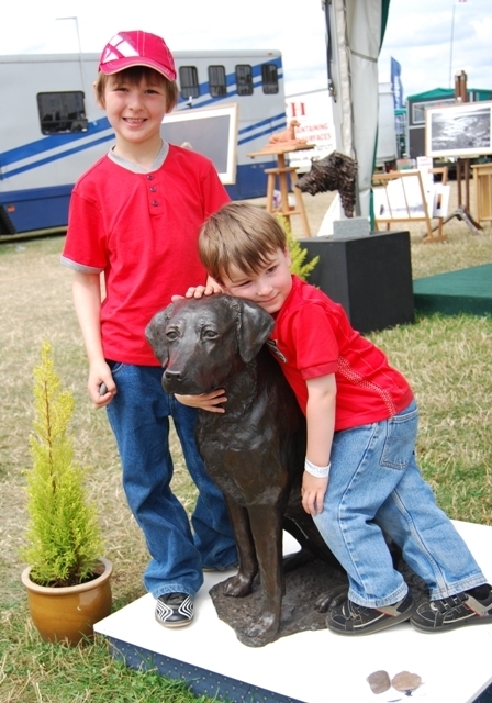 Bronze Labrador dog by JOEL gets a hug