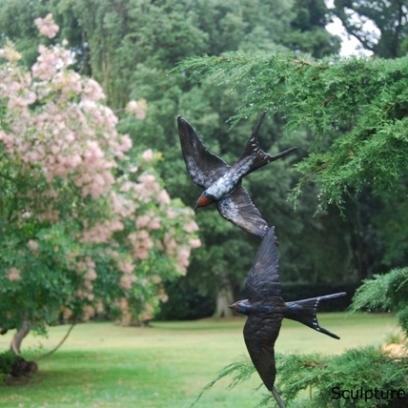 Bronze Swallows by JOEL in Garden Setting