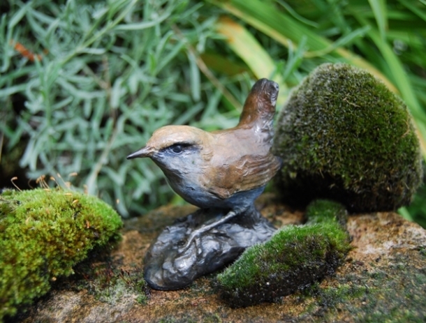Close up of Wren Sculpture against the Moss