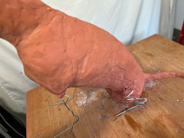 Dog statue progress in clay