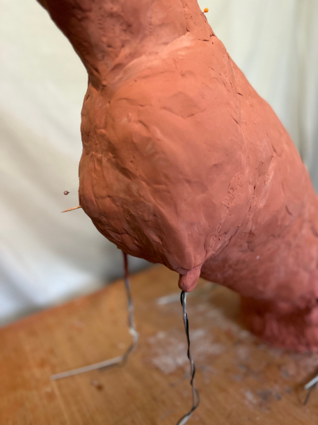 Dog statue progress in clay