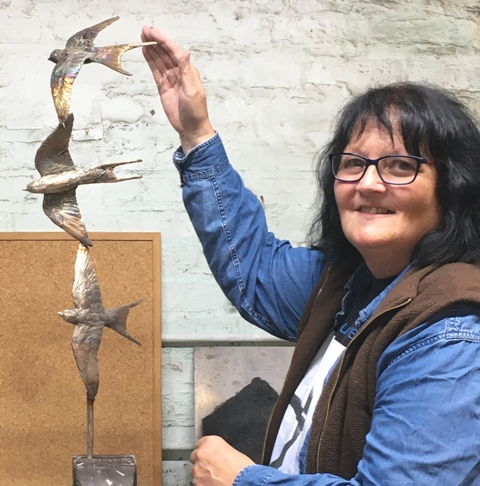Joel Works on Three Bronze Swallows