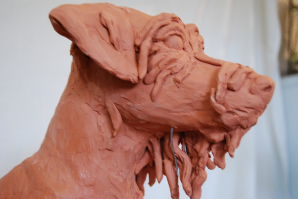 Milo dog sculpture clay stages next the right face