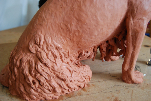 Milo dog sculpture clay stages of right hip