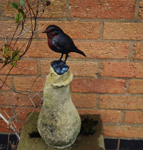 RObin Bright Day on weathered stone pillar