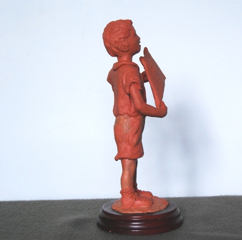 Side view sculpture of boy and kite by JOEL