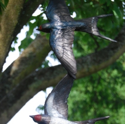 Swallow Bronze mobile by JOEL set amid the tree